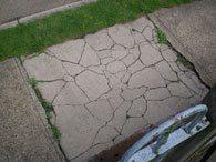 Cracked sidewalk that needs to be repaired