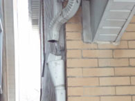 Improperly attached down spout discovered by home inspector